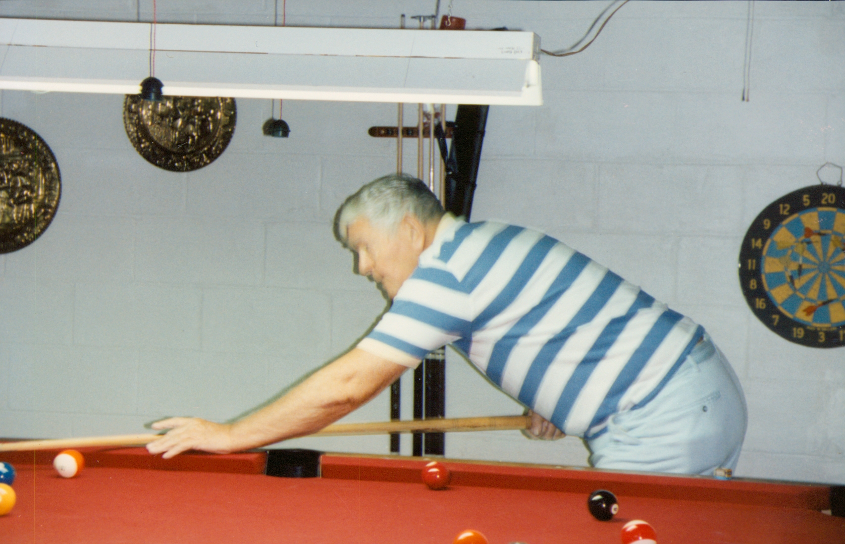 Charles Leo McGarvey lining up a pool shot in Moody, Alabama, during the 1980s