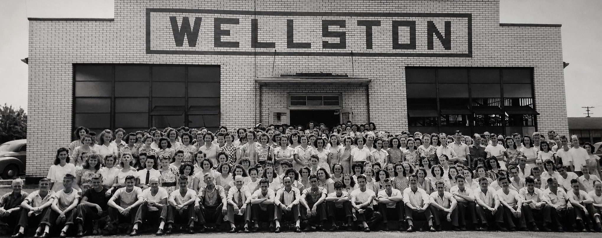 Large group photograph of Hercules factory workers posed outside the Wellston factory