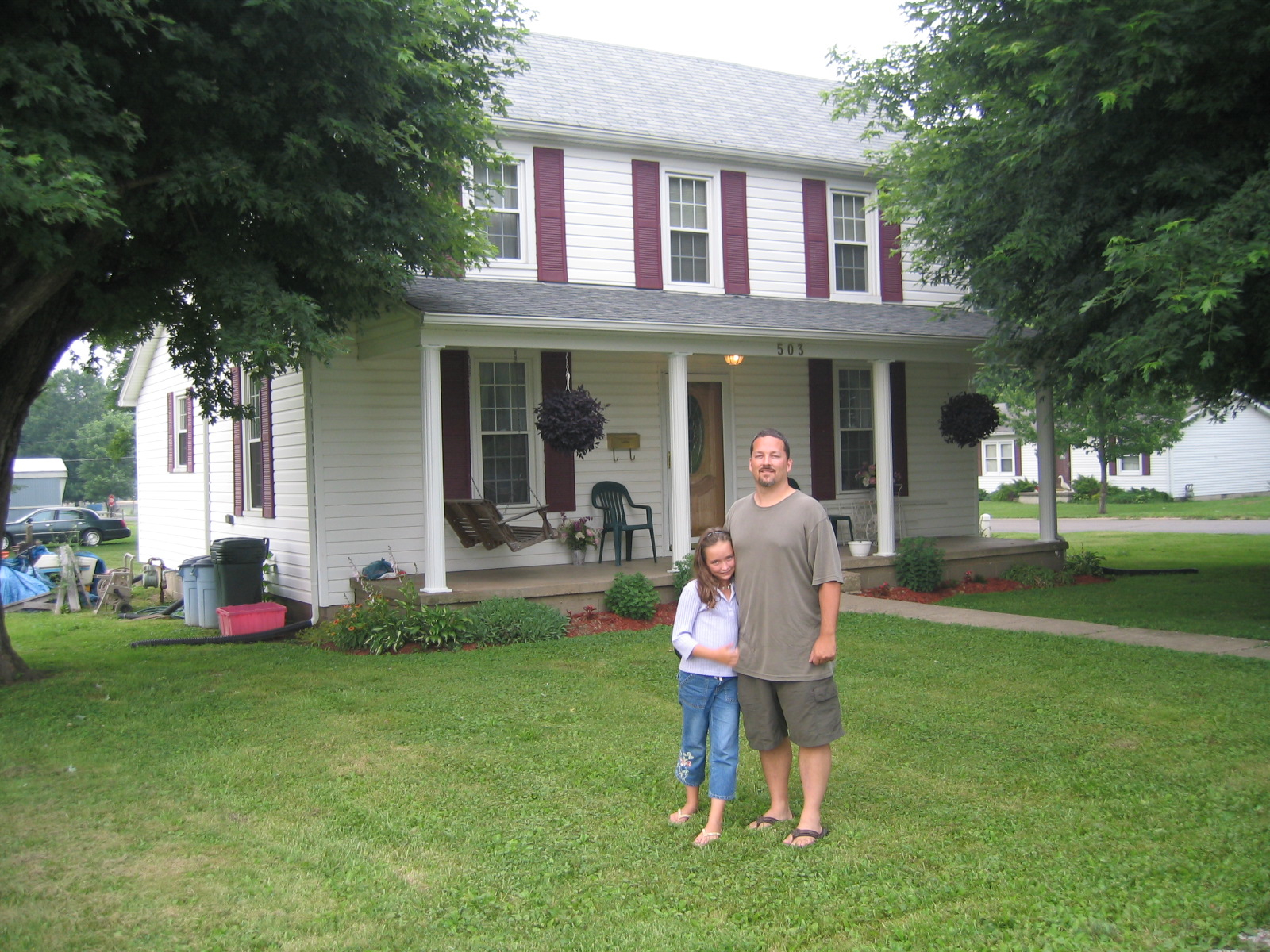 John McGarvey and Mikayla McGarvey in front of the McGarvey family home on West C Street in Wellston in 2004