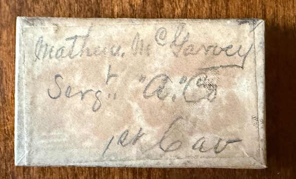 Old medal box with a handwritten label identifying Matthew McGarvey and his cavalry service